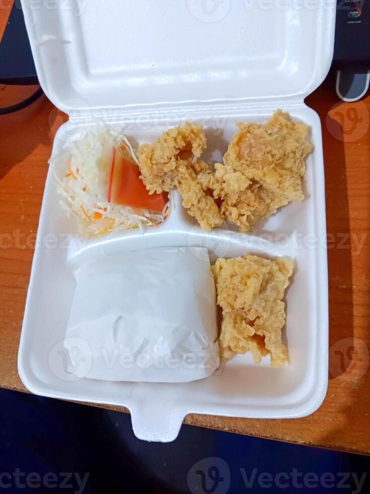 Fried Chicken Meal in Styrofoam Container, Takeout Food, Overhead View. photo