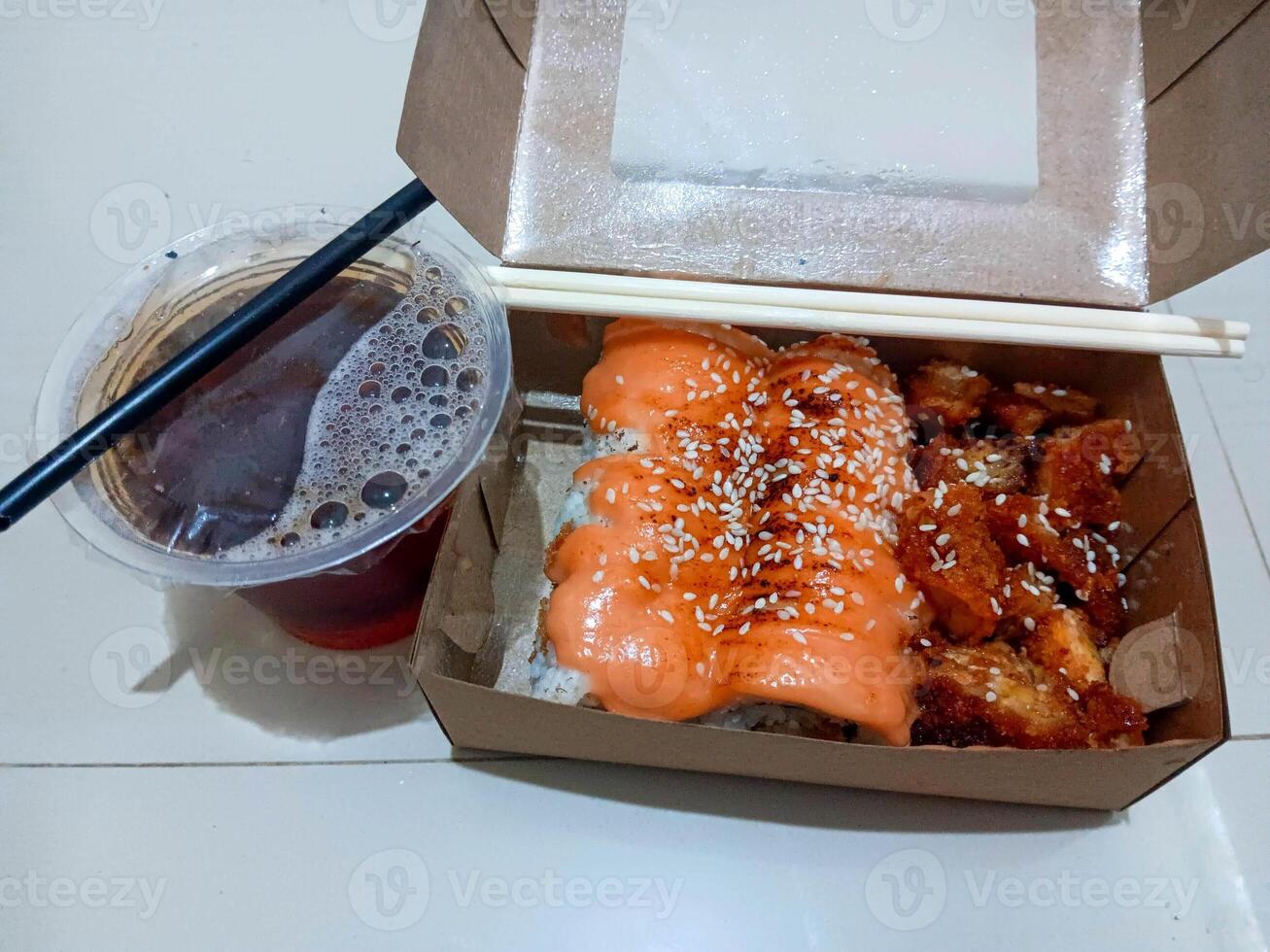 Takeout Sushi and Fried Chicken with Iced Tea A Delicious Asian Fusion Meal photo