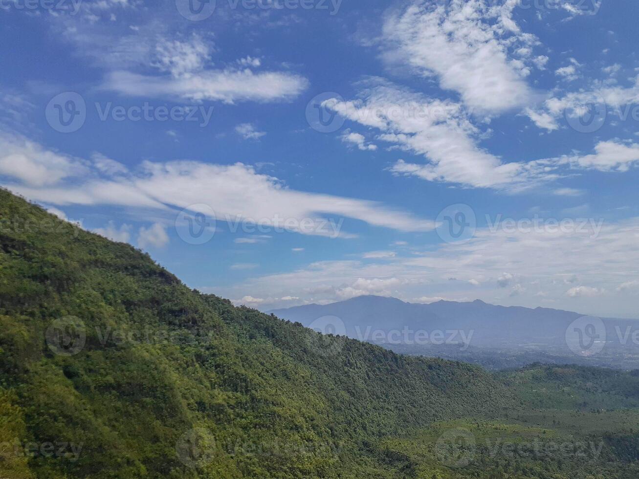Lush Mountain Range Under a Cloud-Kissed Sky photo