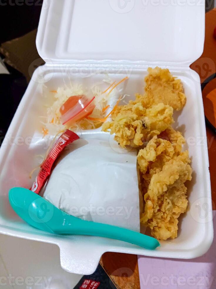 Crispy Fried Chicken in Styrofoam Takeaway Box with Sides photo