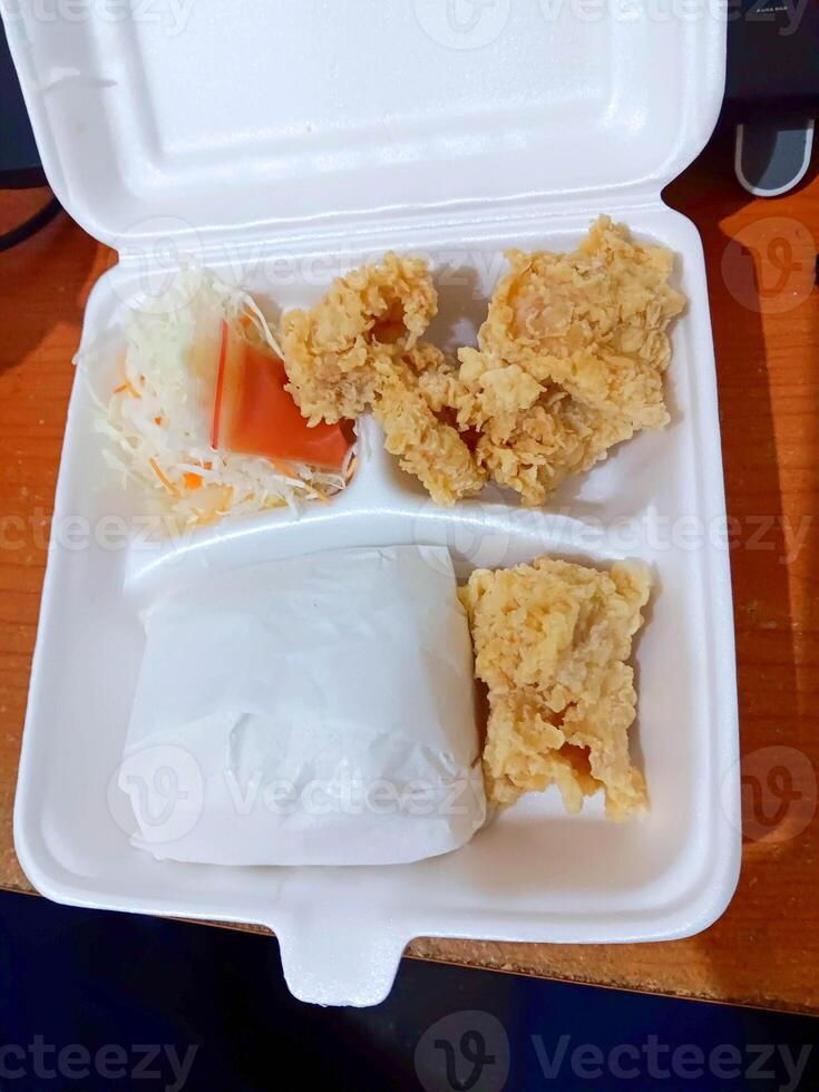 Fried Chicken Meal in Styrofoam Container, Takeout Food, Close-up, Overhead View. photo