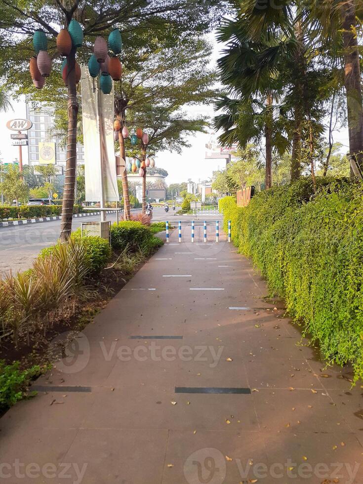 Urban Pathway with Lanterns and Lush Greenery in Jakarta, Indonesia photo