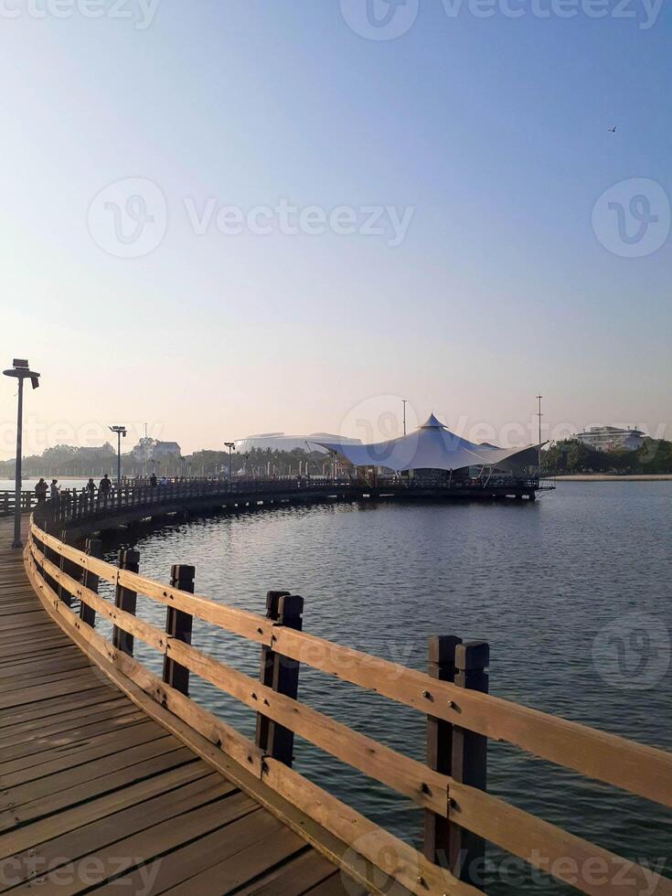 Serene Wooden Pier Leading to a Waterside Pavilion at Ancol Beach, Jakarta photo
