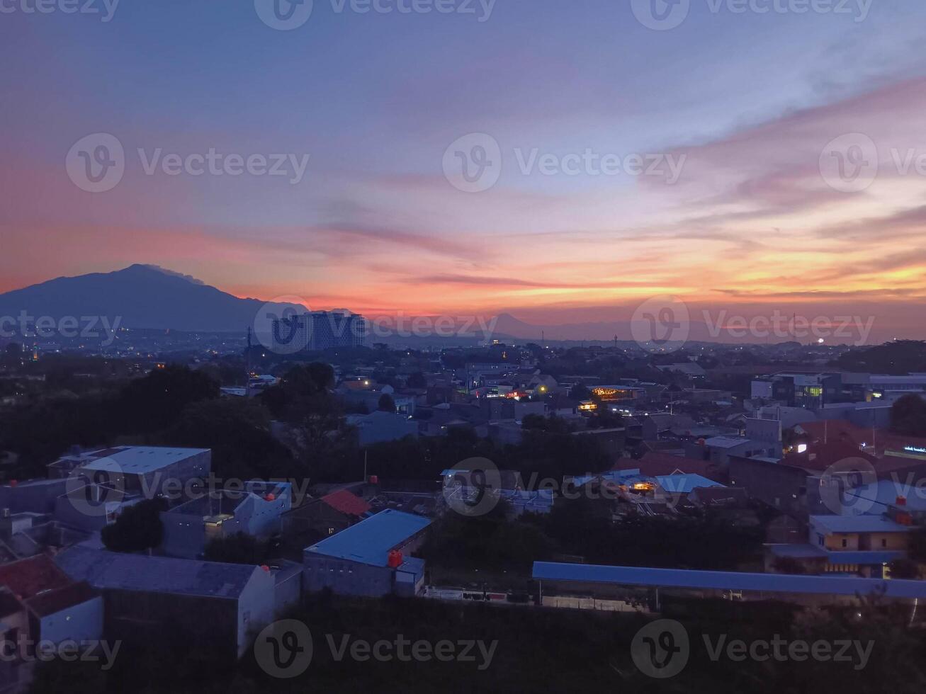 Bandung Cityscape at Dusk Mountain View, Vibrant Sky, Urban Twilight photo