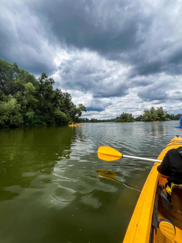 Kayaking on the lake under dramatic cloudy sky photo
