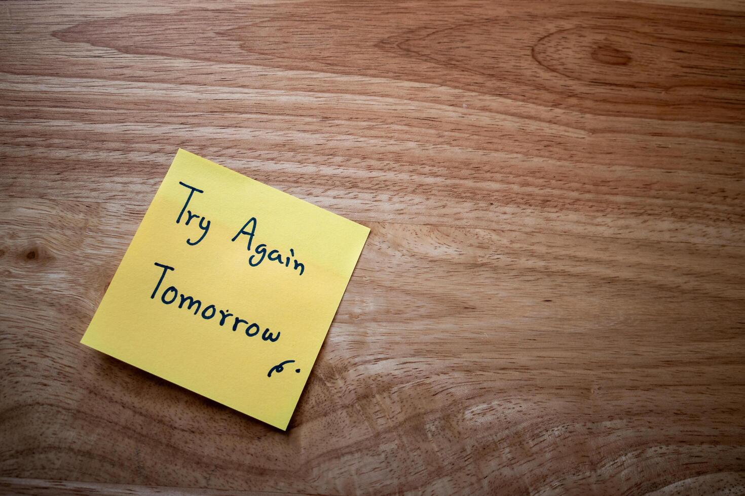 Motivational note to self desk sticky note organized workspace close-up personal growth photo