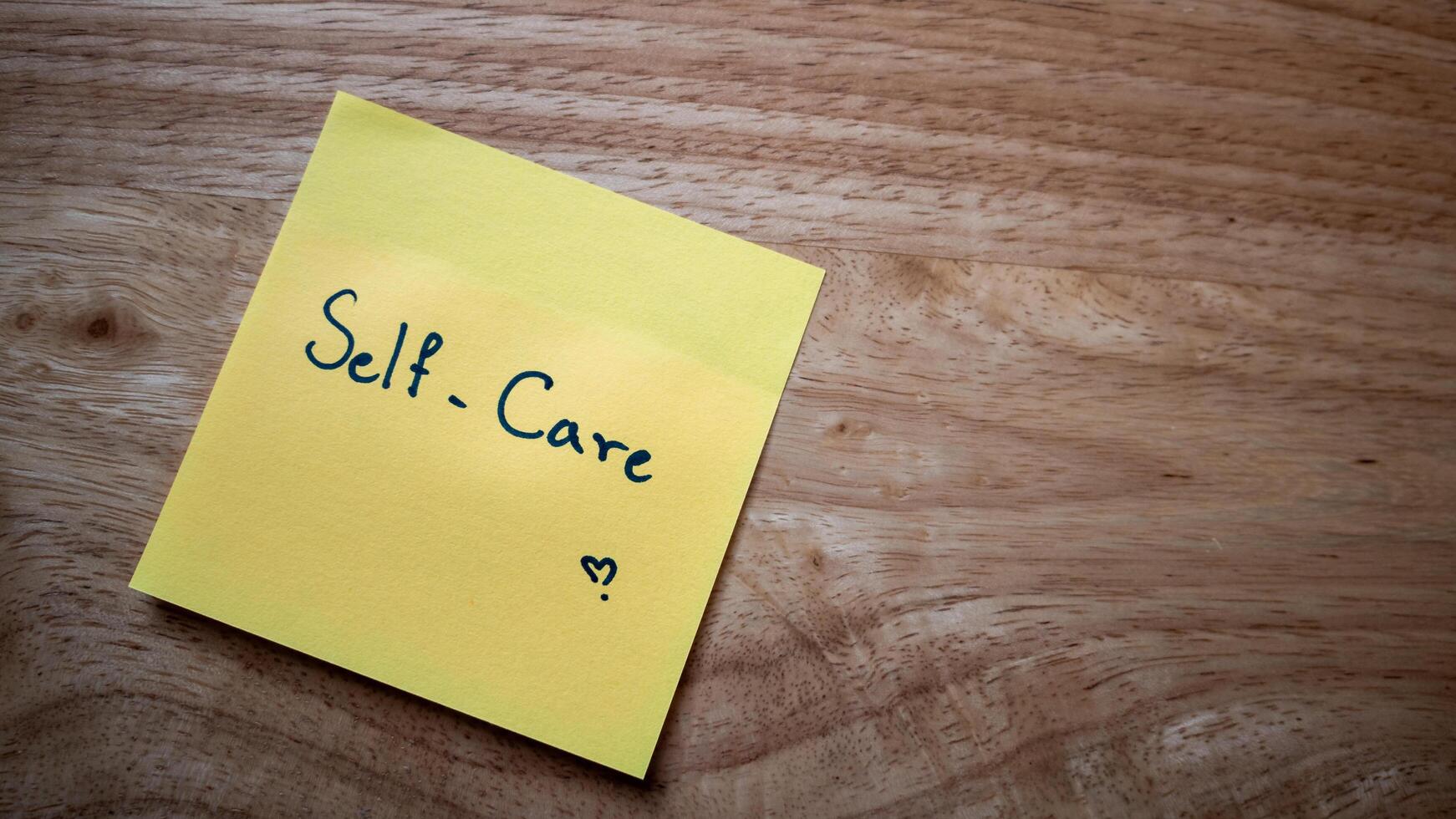 Self-care practices for a balanced life home office sticky note relaxing close-up mindfulness photo