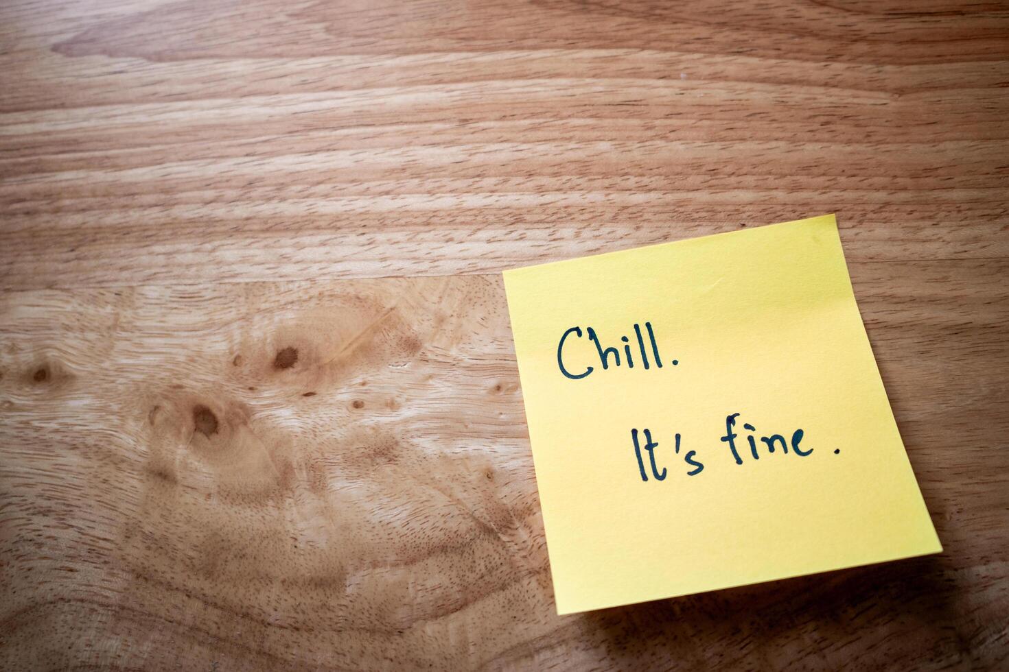 Chill message sticky note home office desk motivational quote cozy environment close-up view photo
