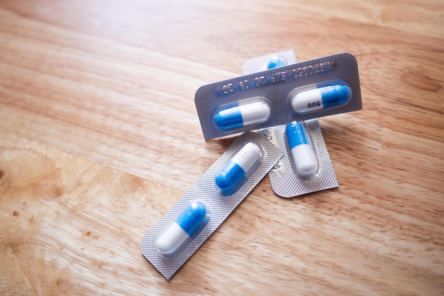 Medication capsules wooden surface medicine product close-up clinical use photo