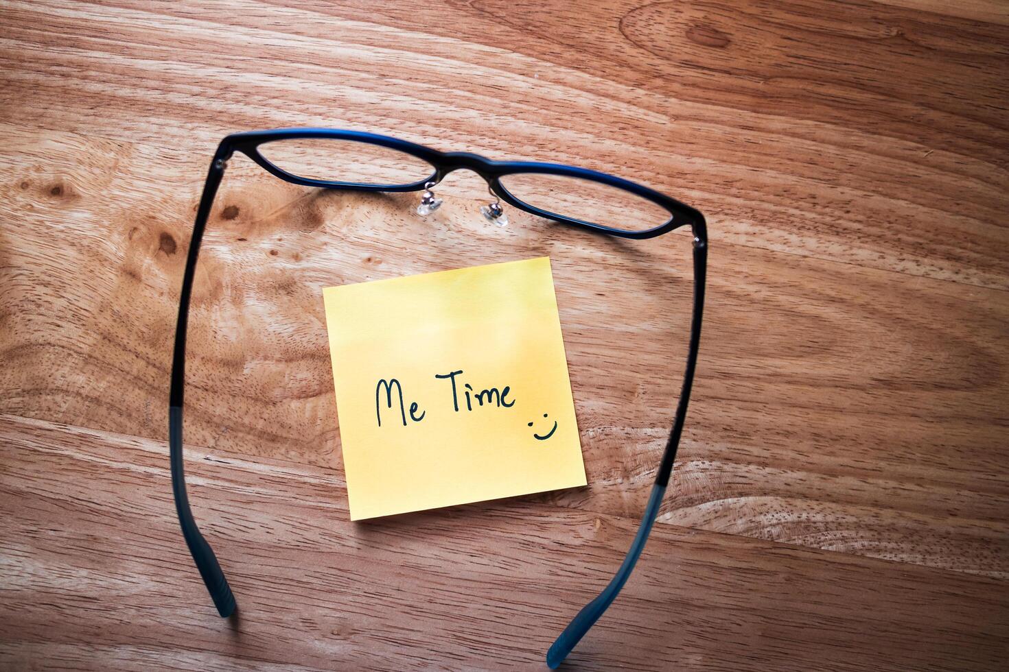 Relaxing self-care moment glasses and note home office cozy environment close-up mindfulness photo