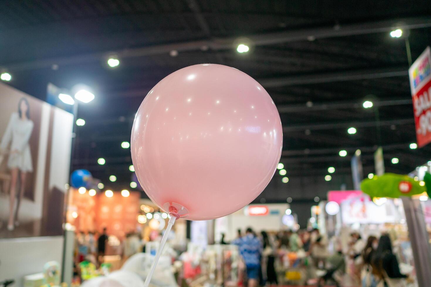 Joyful celebration with pink balloon at indoor event vibrant atmosphere captured moments photo