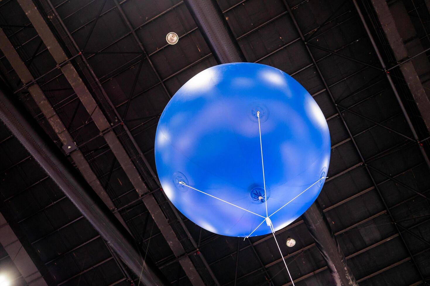 Aerial demonstration of a blue balloon indoor exhibition modern environment upward view aviation concept photo