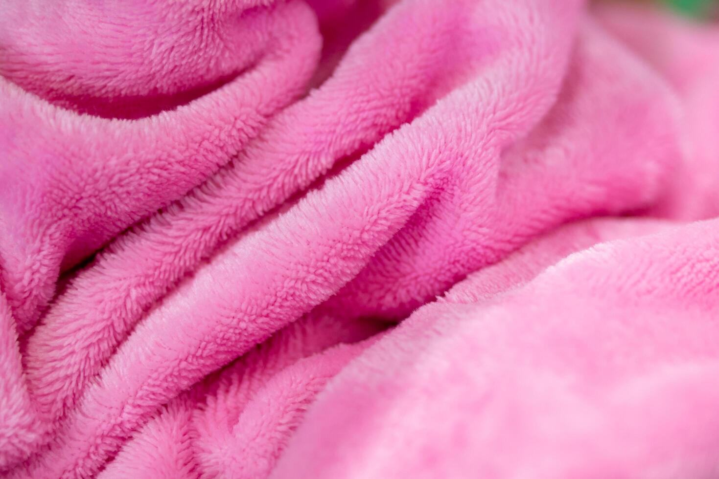 Cozy pink blanket indoor setting textile close-up soft environment texture focus photo