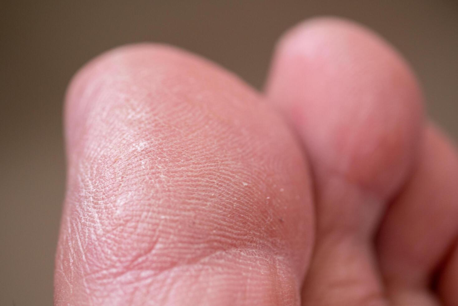 Close-up action of human hand skin texture indoor setting macro detailed view touch sensation photo