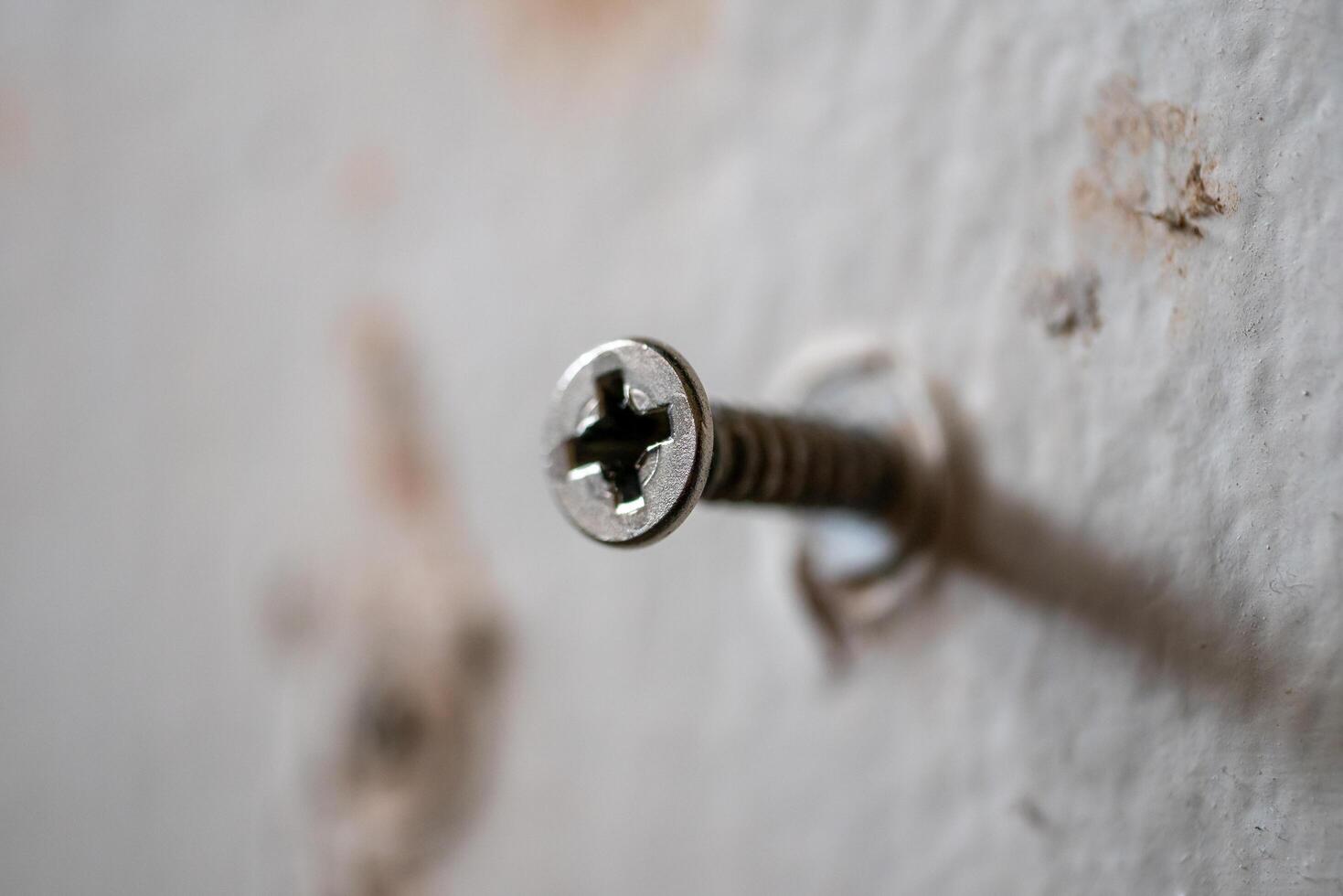 Close-up of screw installation process interior wall home environment macro view diy concept photo