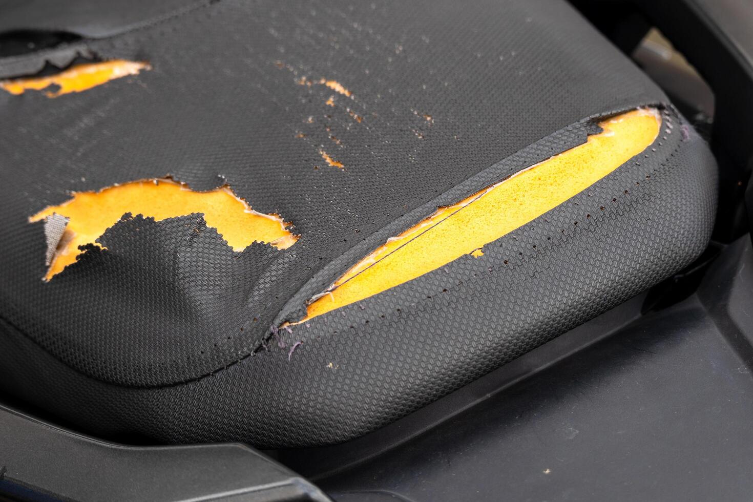 Damaged office chair cushion workspace furniture indoor close-up wear and tear photo
