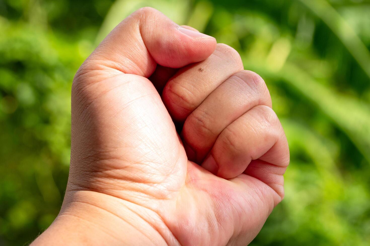 Determined gesture of strength nature background close-up shot outdoor setting empowerment concept photo
