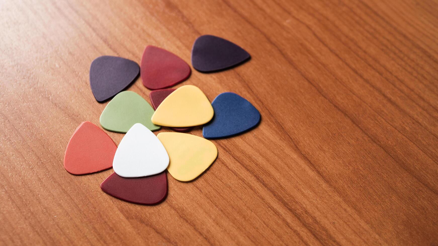 Colorful guitar picks arranged wooden surface artistic still life creative space close-up view photo