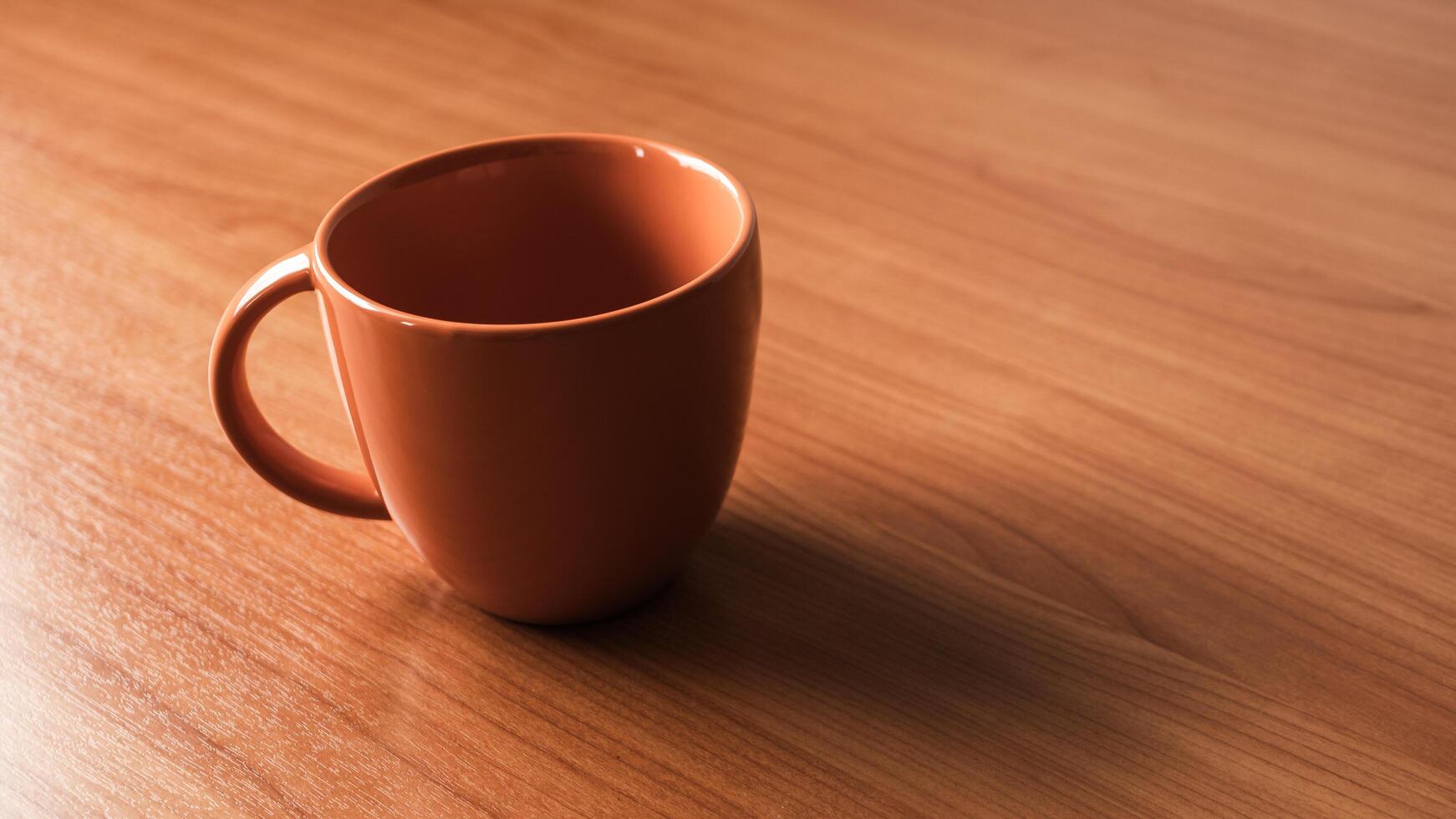 Coffee cup wooden table indoor setting still life warm ambiance close-up perspective photo