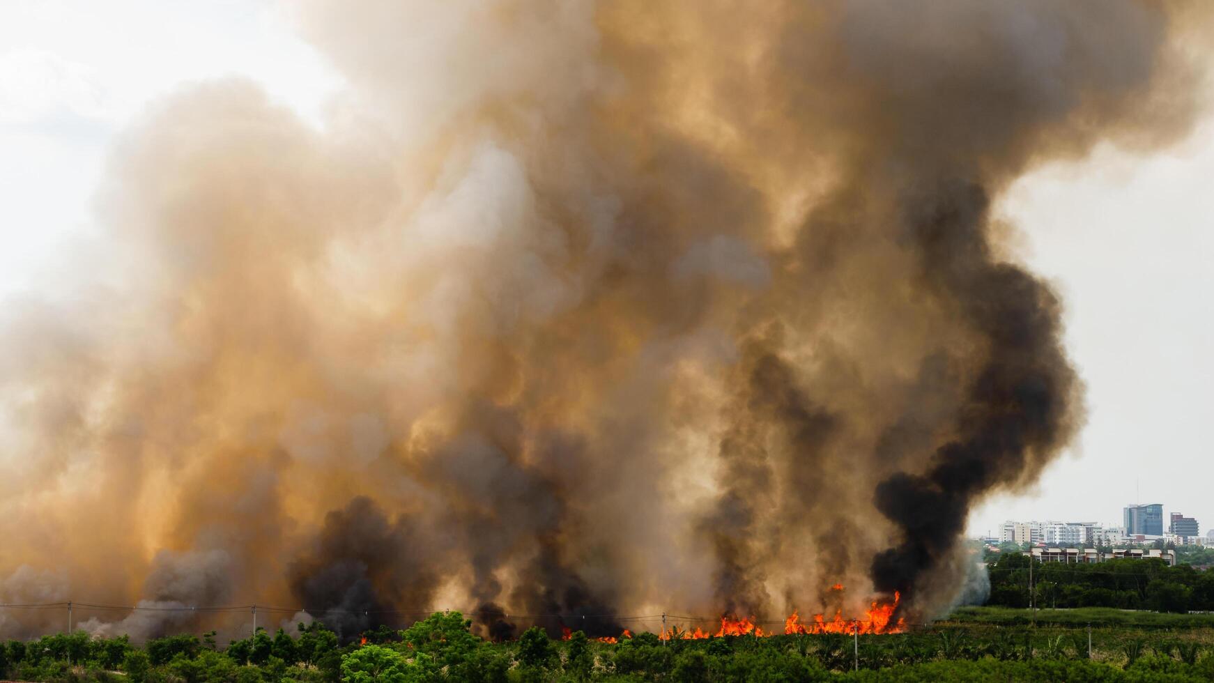 Wildfire eruption urban area natural disaster smoky environment aerial view environmental crisis photo