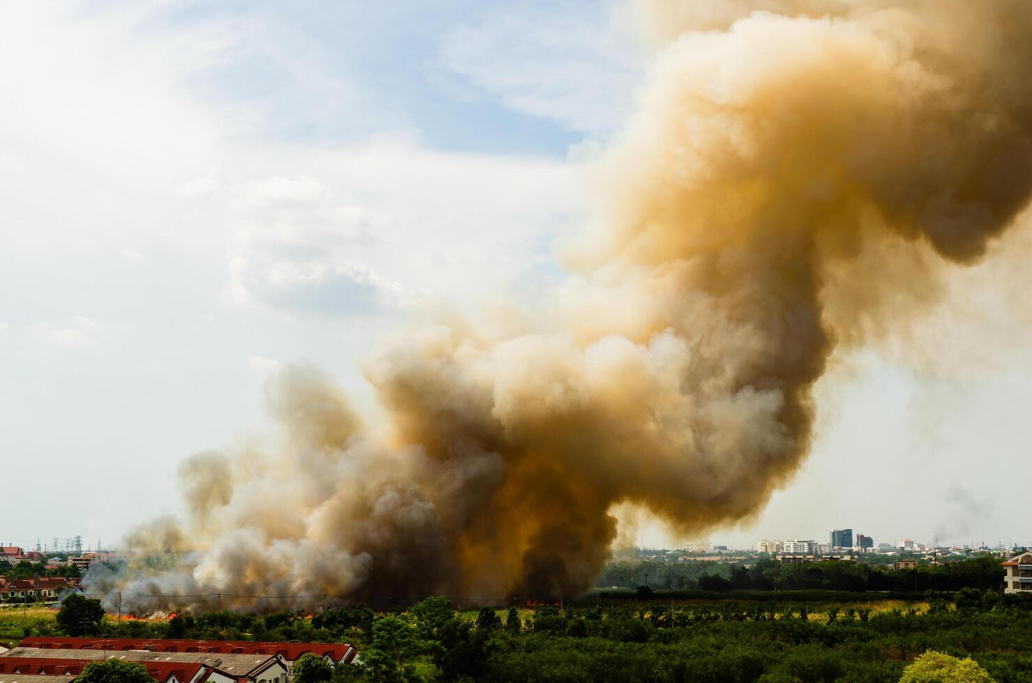 Fire incident in urban area smoke billowing environmental hazard aerial view emergency response photo