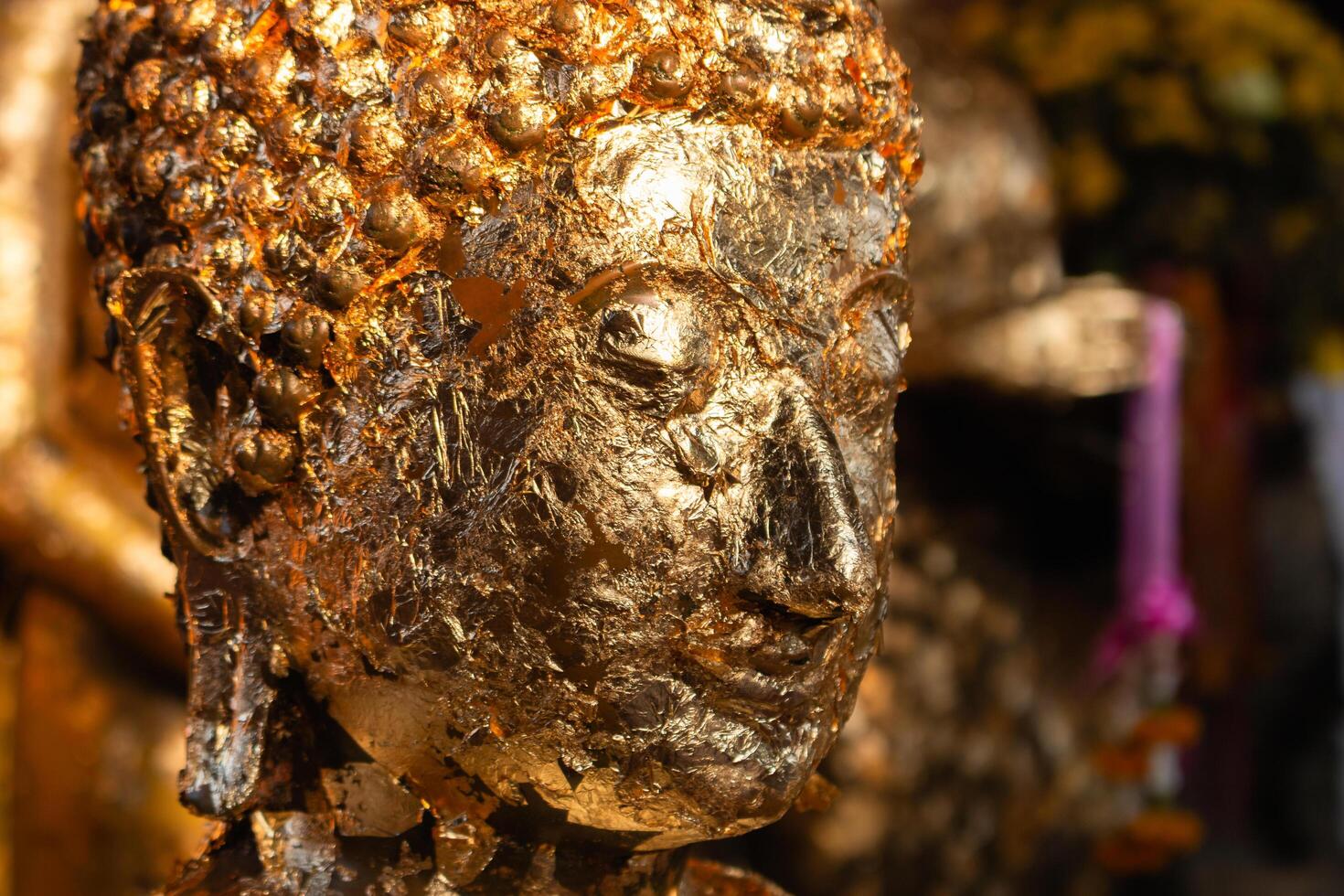 Golden buddha statue close-up cultural site serene environment artistic perspective photo