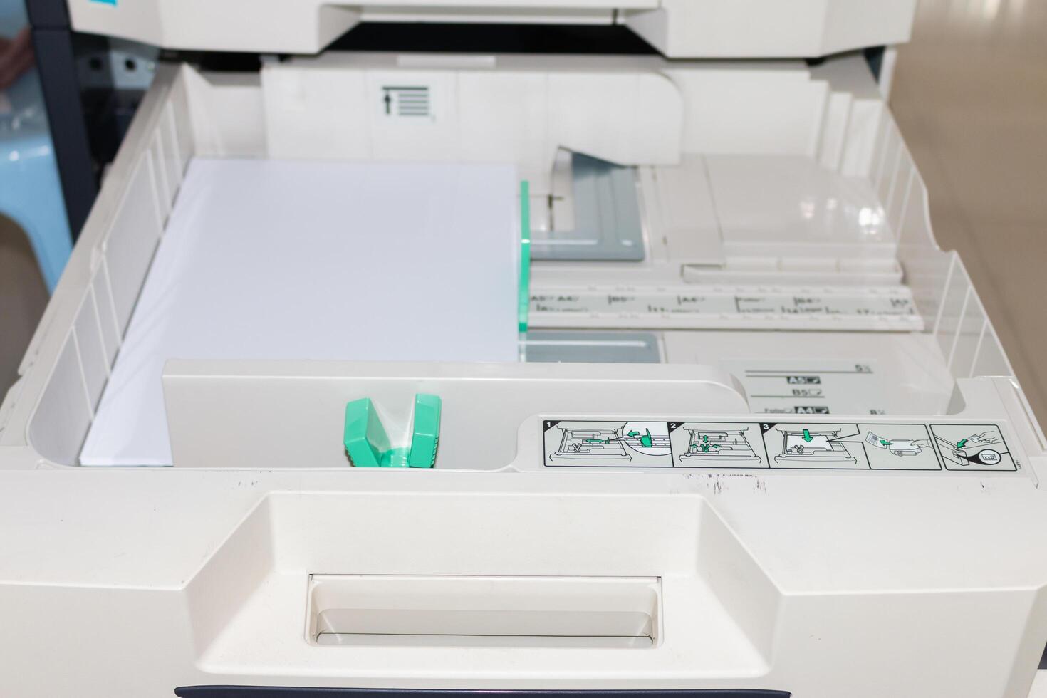 Office printer maintenance routine office space how-to guide indoor setting close-up view efficiency tips photo