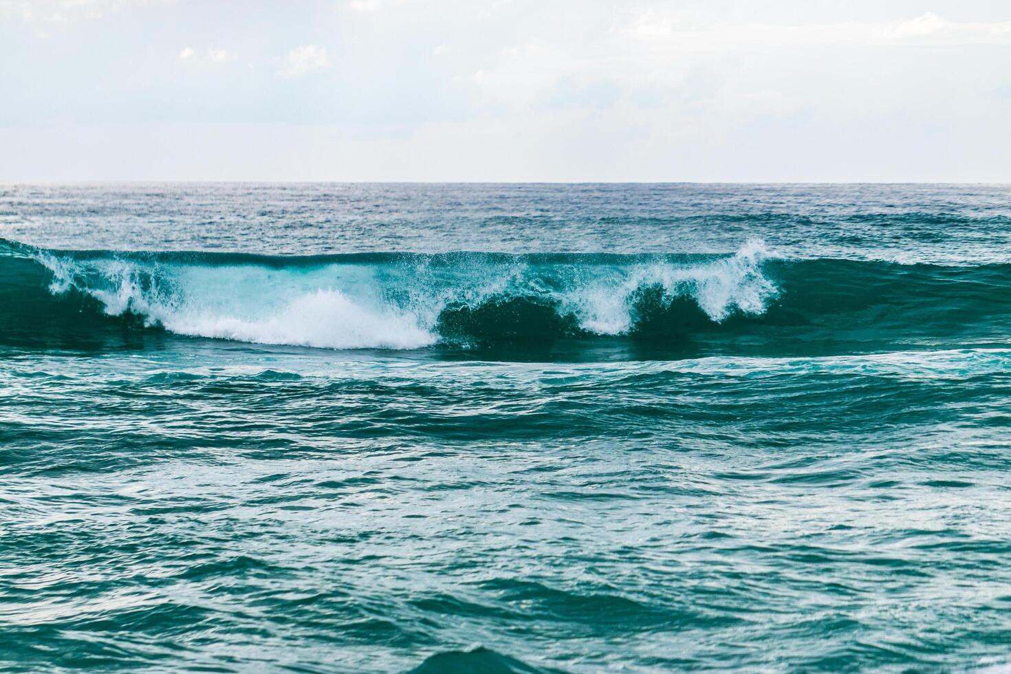 Waves crashing serene beach coastal nature seaside landscape tranquil ocean view for relaxation photo