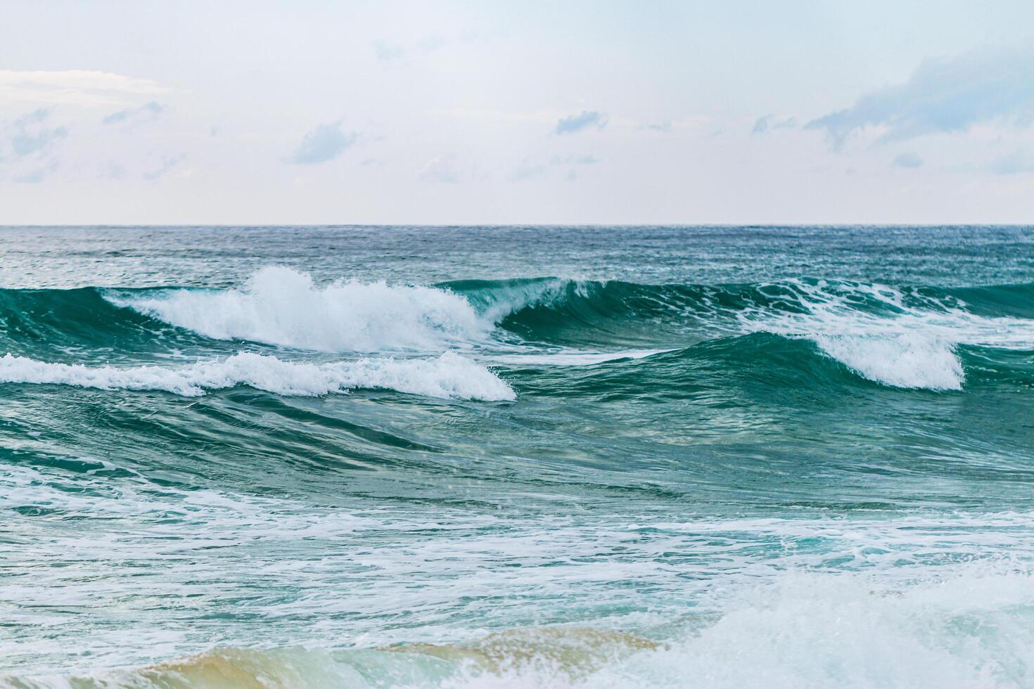 Waves crashing the shore coastal beach ocean serene environment wide view nature's beauty photo