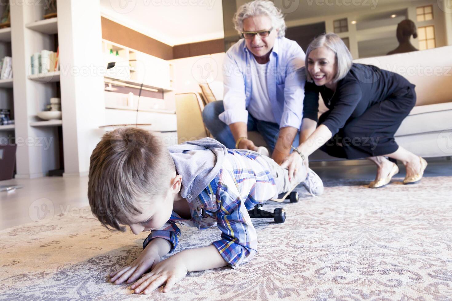 couple of happy grandparents are fun nephew with skateboard photo