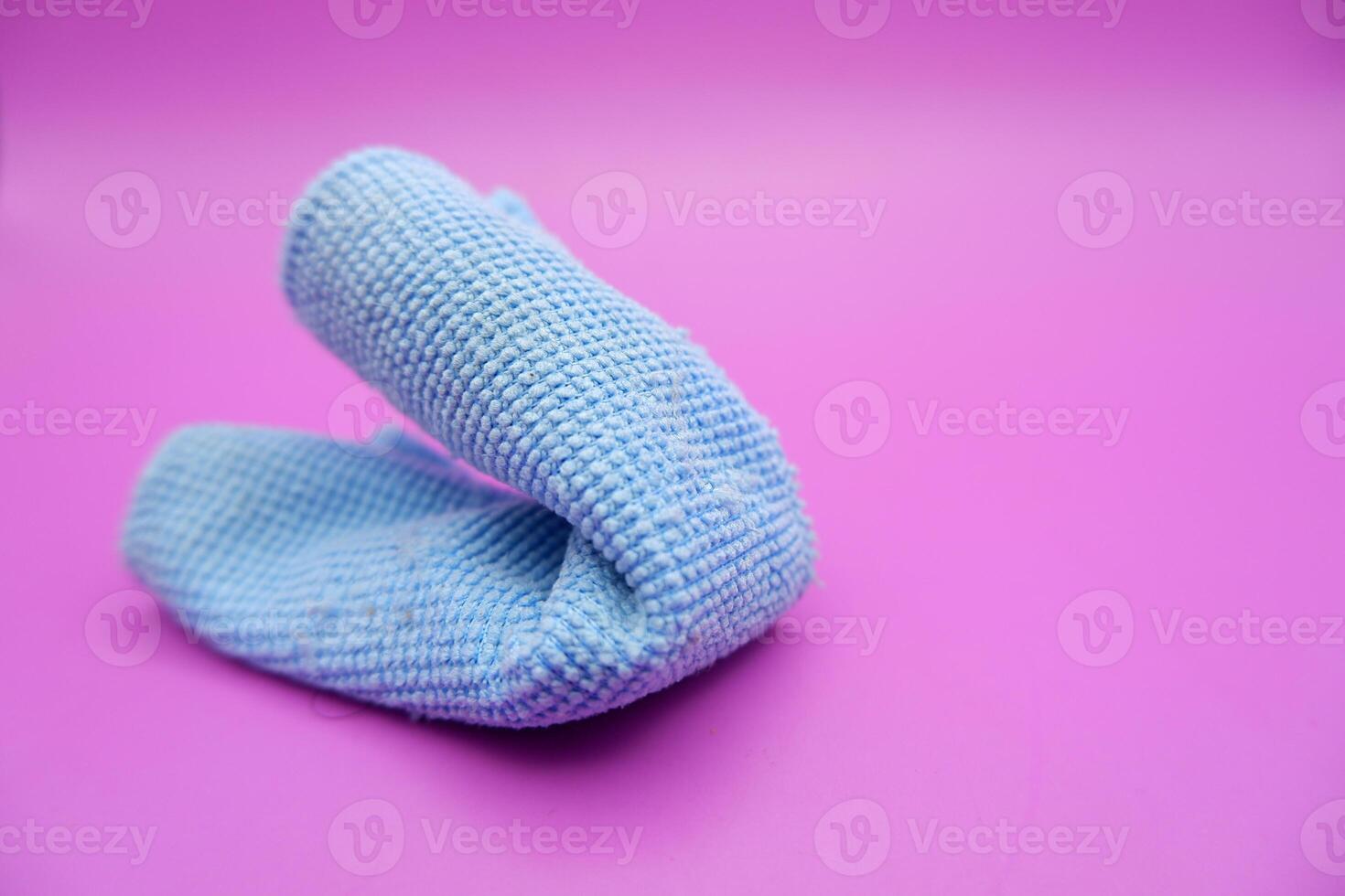 Blue Microfiber Cleaning Cloth on Pink Background photo