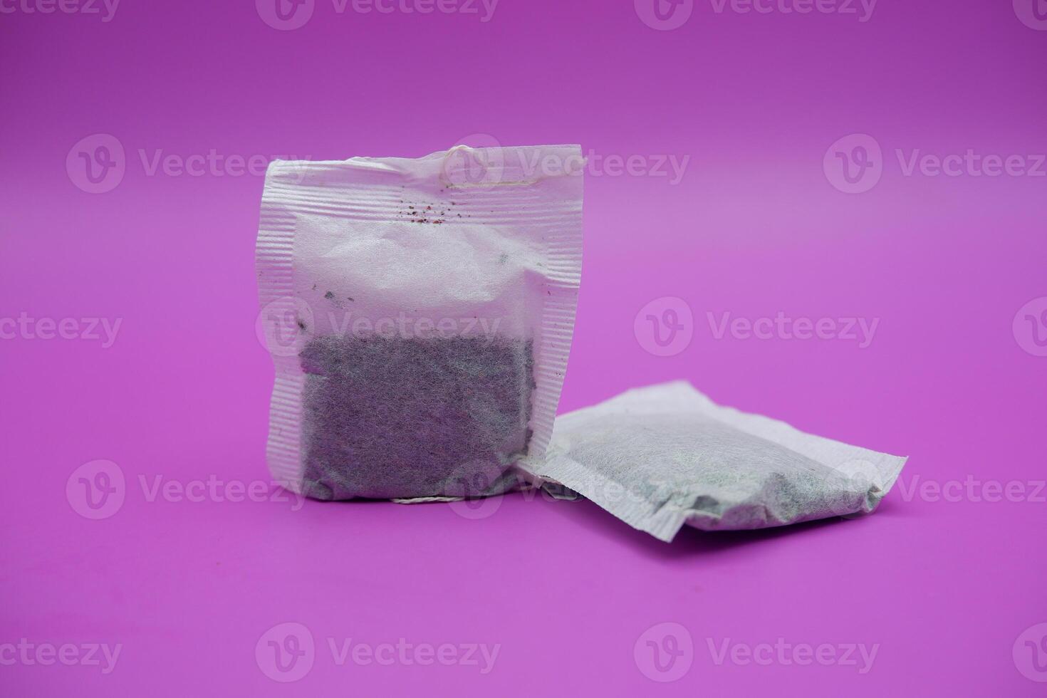 Two Tea Bags on Purple Background photo