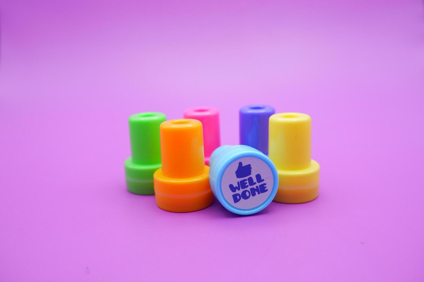 Well Done Stamp and School Reward Tools on Purple Background photo