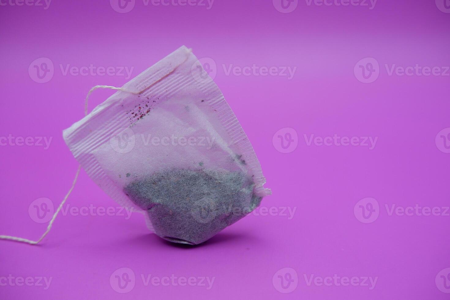 Simple Teabags with String on Pink Surface photo