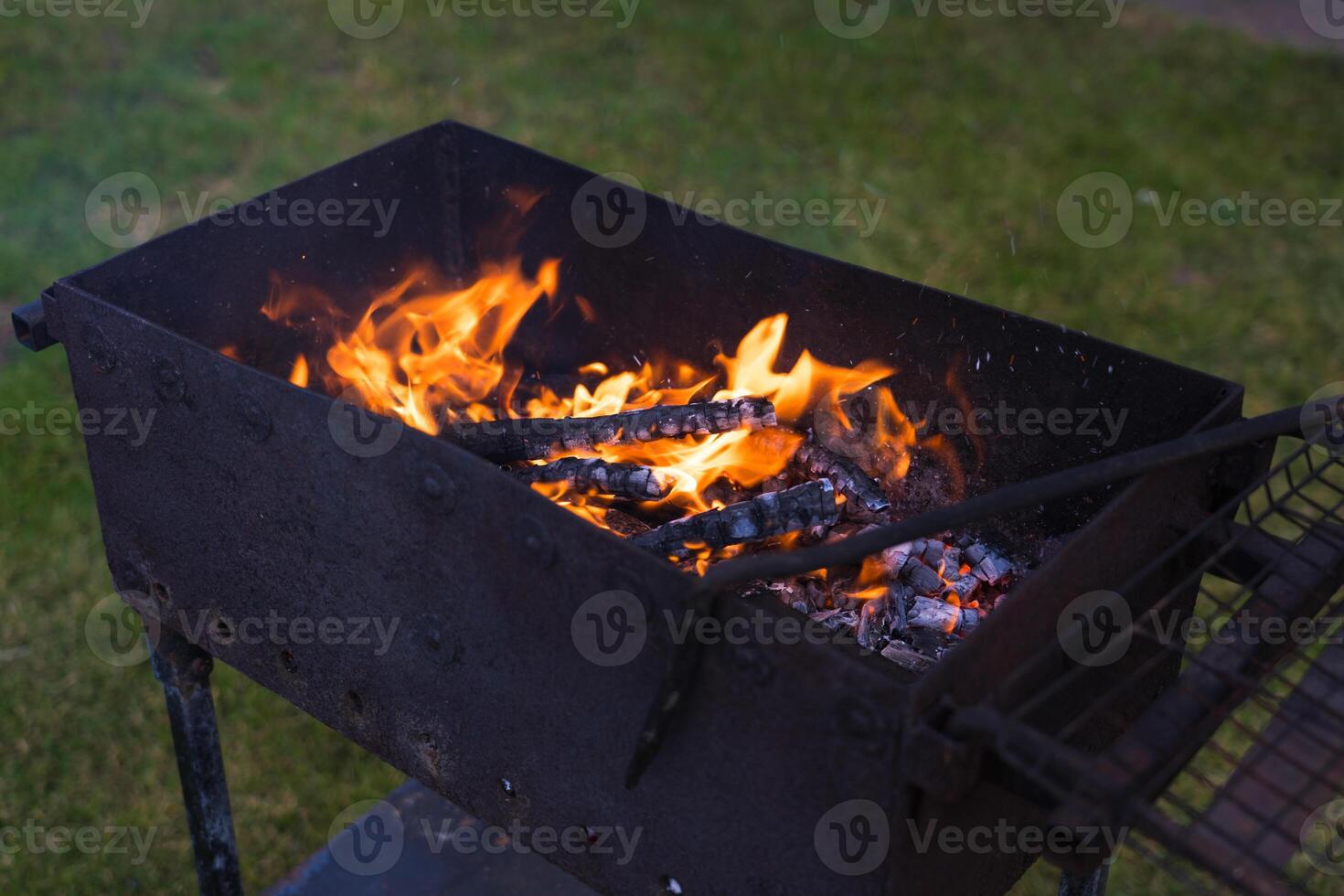 Smoldering coals in the grill. Coals in the grill. Evening in the village photo