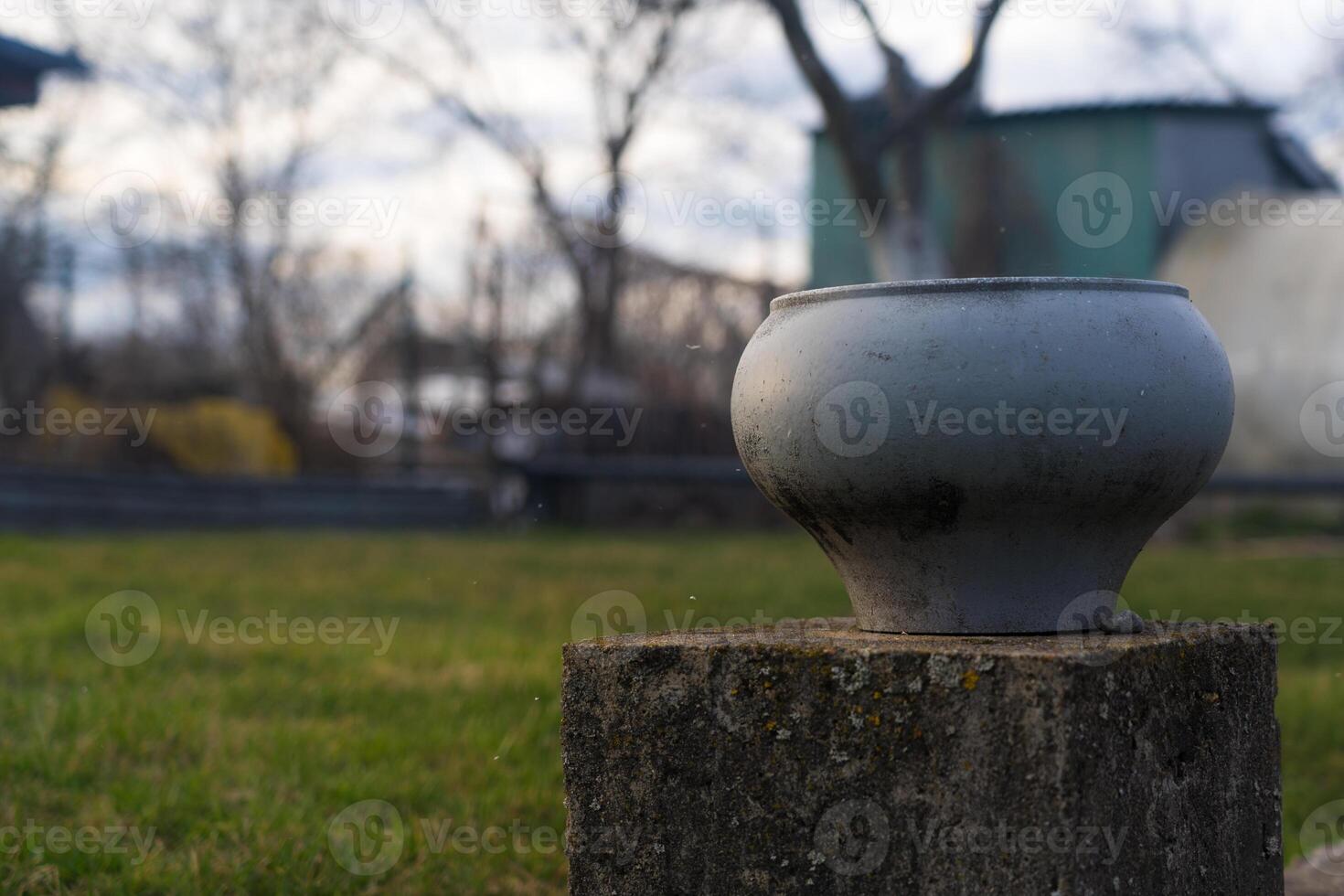Cast-iron pot stands on a concrete foundation. Soviet cast iron pot photo