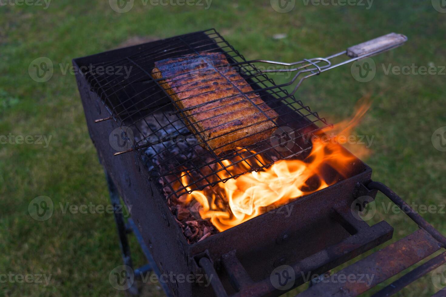Roast the ribs on the grill. Cooking meat on the grill. Village life photo