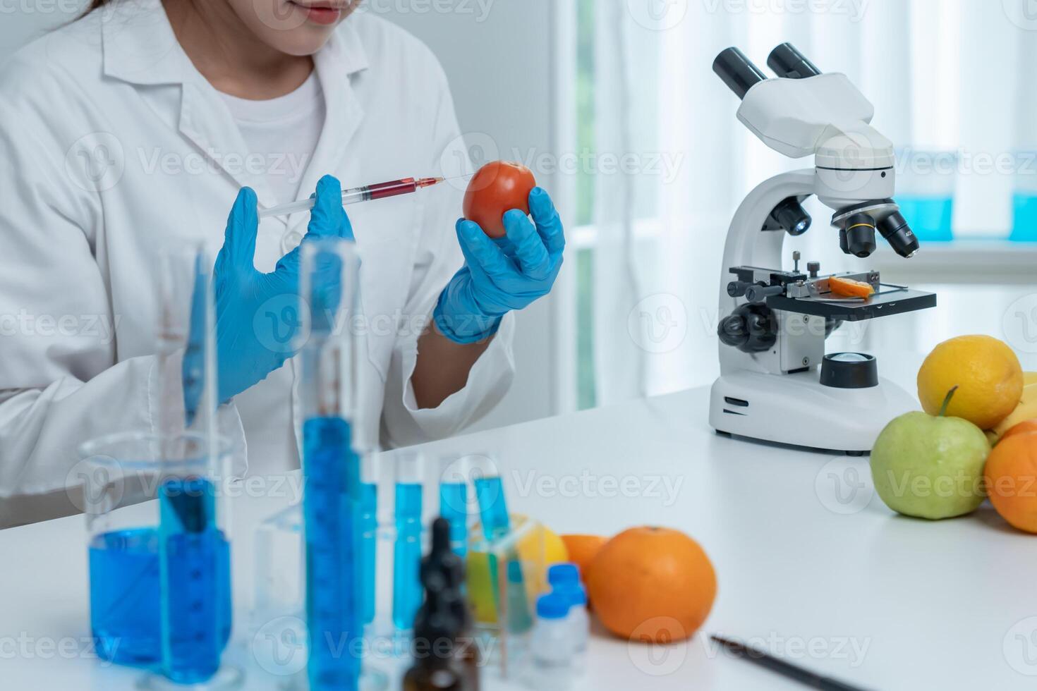 Scientist studying fruit in laboratory setting photo