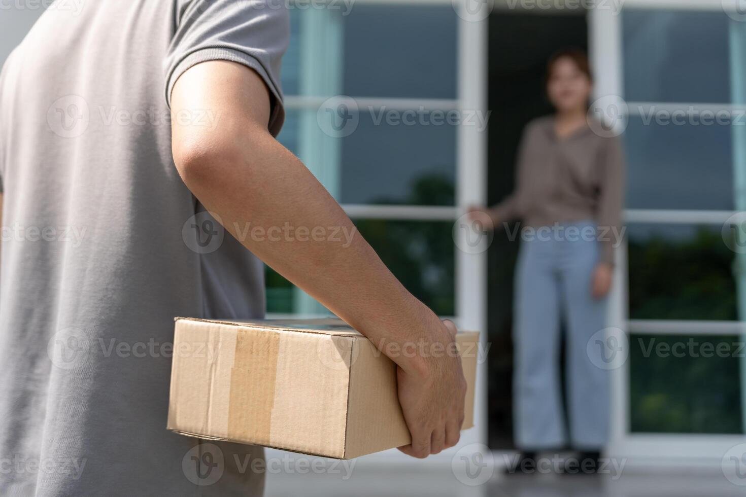 Happy smile woman receives boxes parcel from courier in front house. Delivery man send deliver express. online shopping, paper containers, takeaway, postman, delivery service, package photo