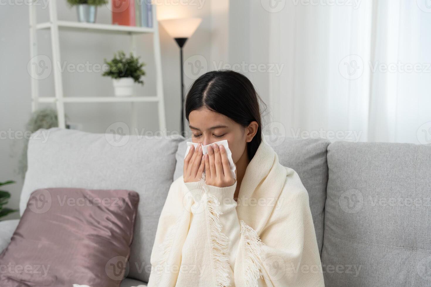 Woman wrapped in a blanket feeling unwell photo