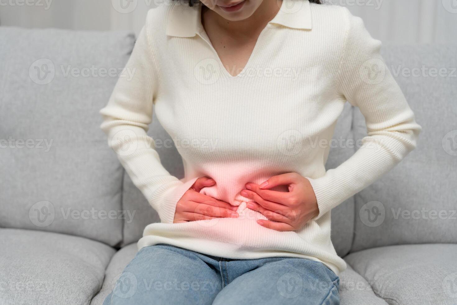 stomach ache Asian women have abdominal pain, indigestion, gastritis, menstrual cramps, flatulence, diarrhea, distention, colon cancer, belly inflammation problem, suffer food poisoning. photo