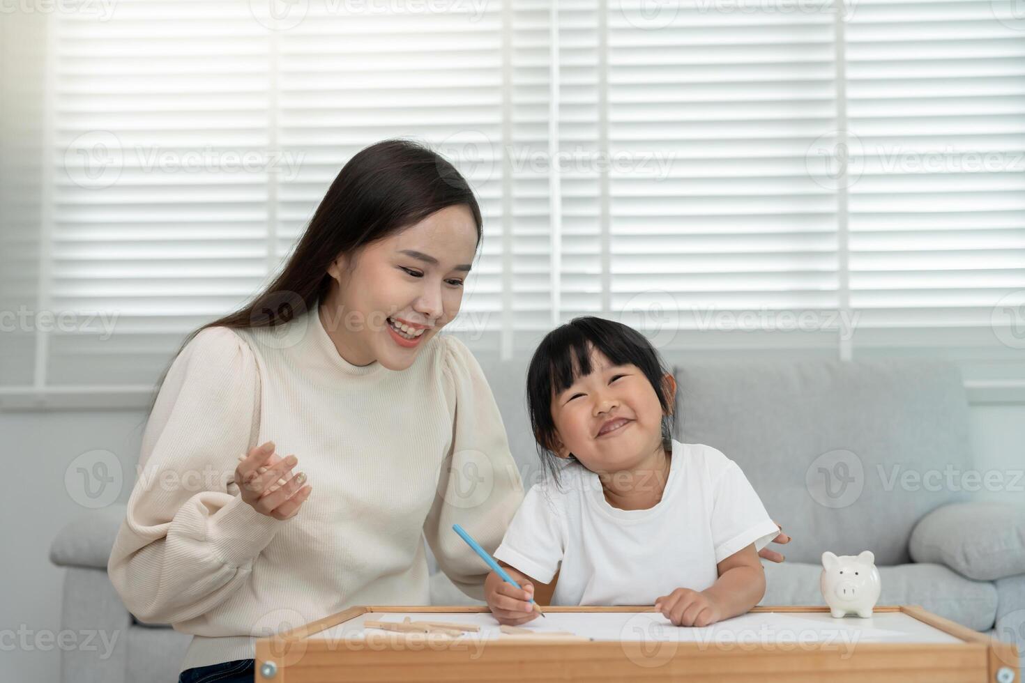 Mother day, Happy Asia mother play and learn drawing for little girl. Funny family is happy and excited in the house. Mother and daughter having fun spending time together. Holiday, Activity. photo