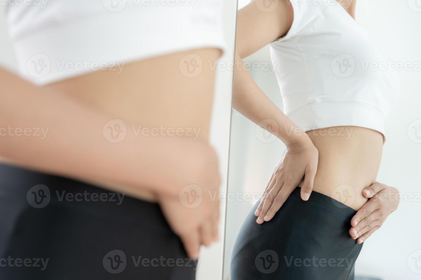 Women show results of diet. Beautiful shape. female look mirror for check shape body have a reduced waist size after under going a weight loss corse. balance, control, routines, exercise photo
