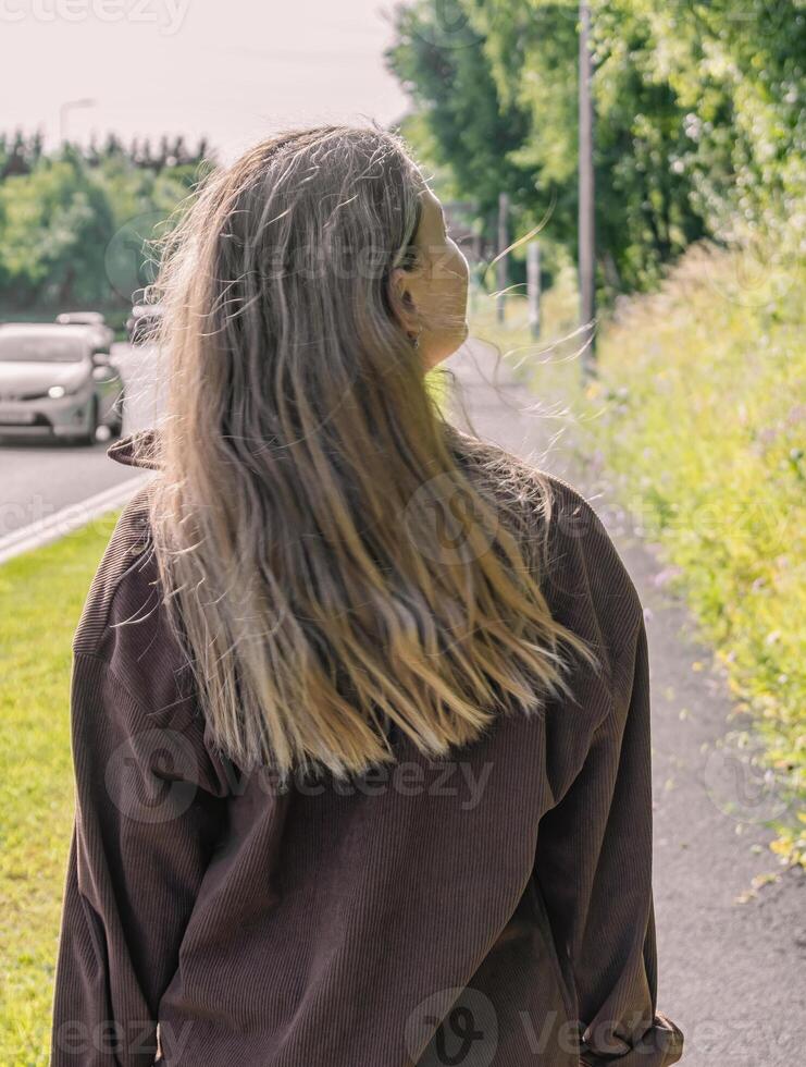 A Person Walking Alongside a Beautiful Road Surrounded by Nature and Scenic Landscape photo
