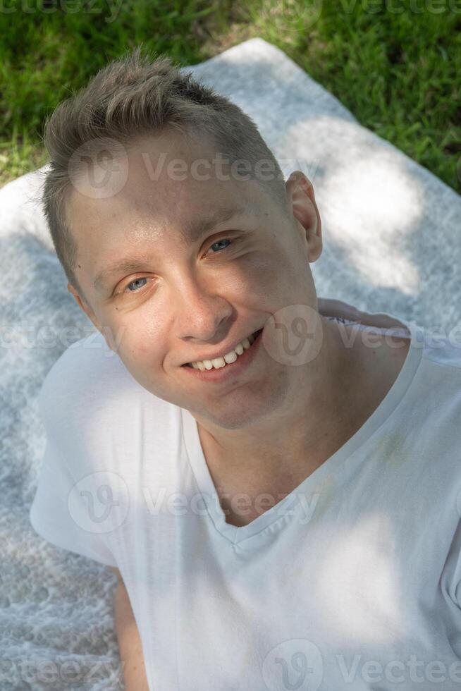 A Joyful Young Man Enjoying His Time While Relaxing Outdoors Under Natural Light and Sunshine photo