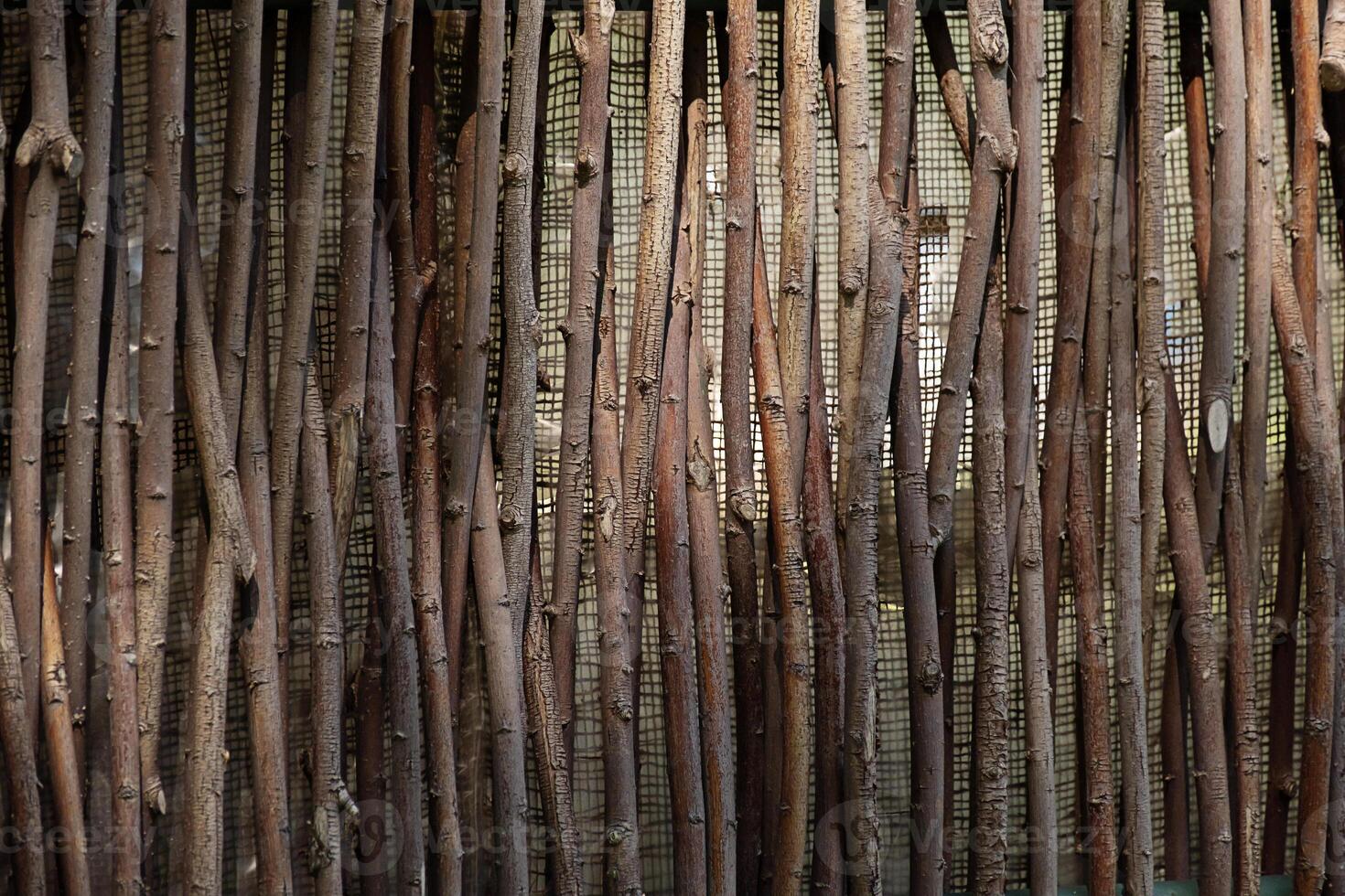 Brown wooden sticks fence texture. Natural organic background. Rustic garden screen material. photo
