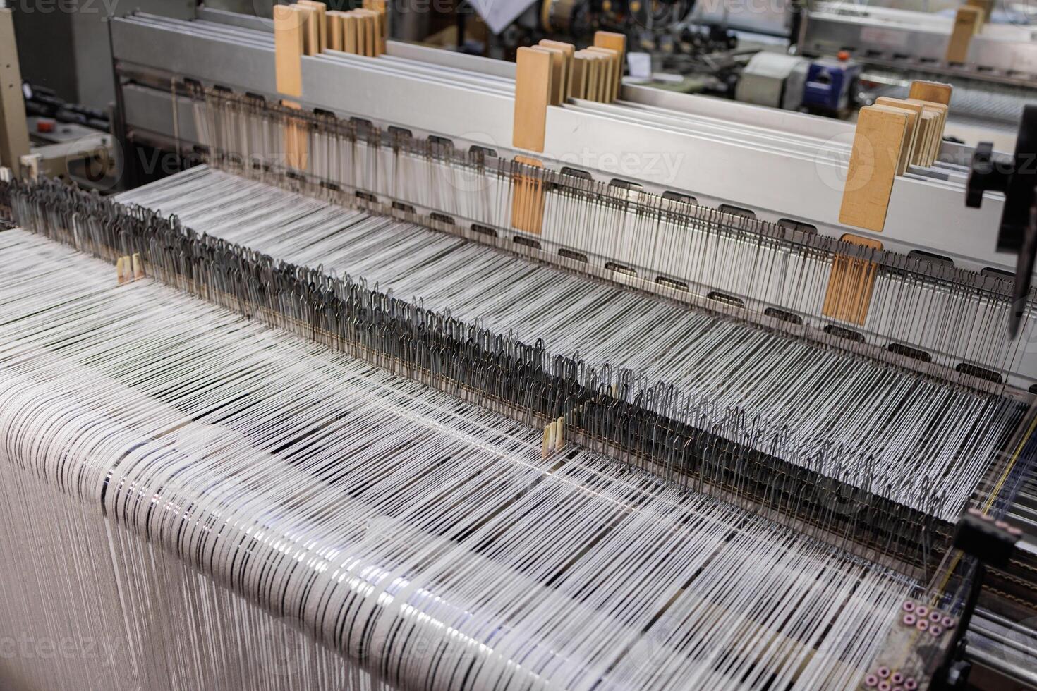 Closeup of Factory Loom with Wool Threads in Industrial Textile Manufacturing Process photo