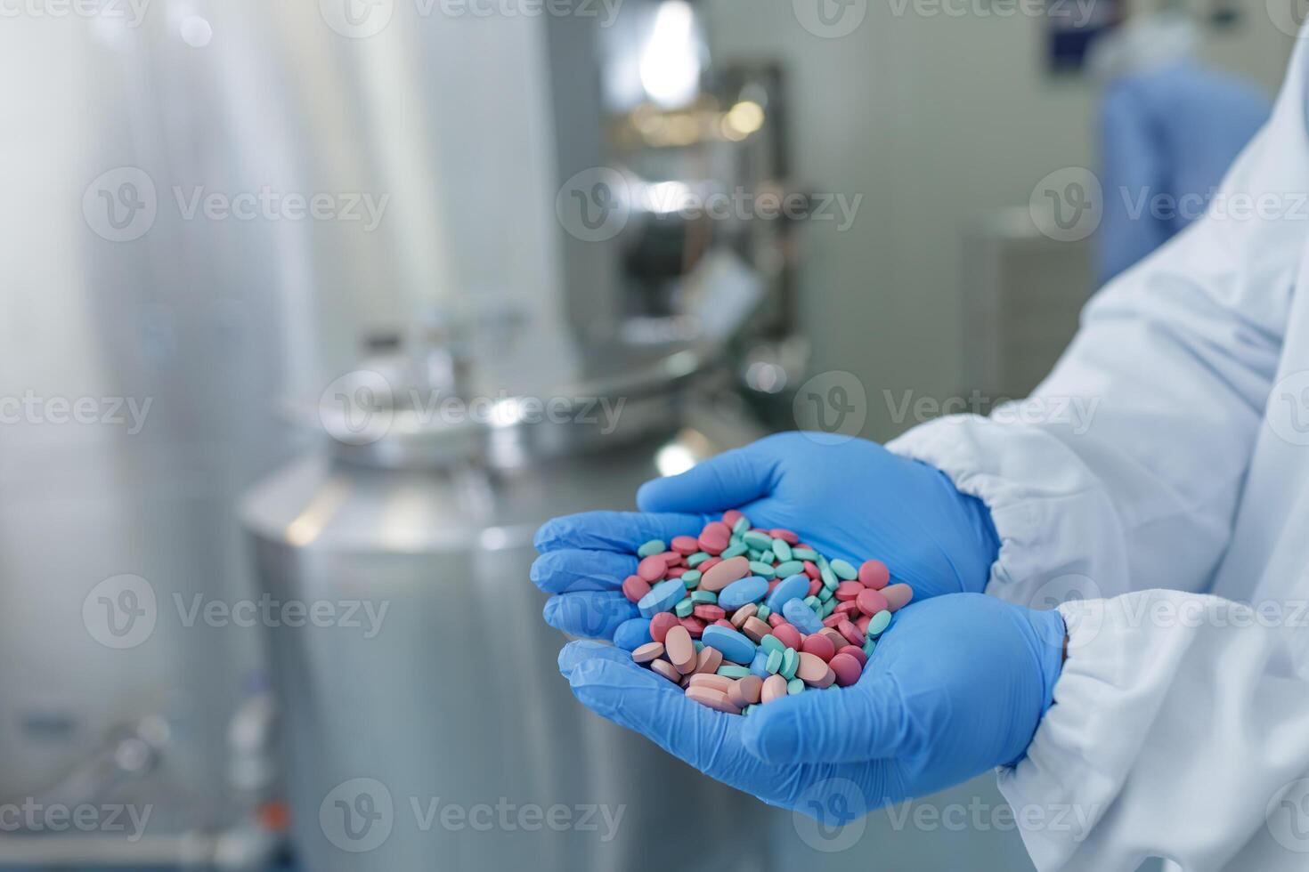 Pharmaceutical Worker Holds Colorful Pills in Sterile Manufacturing Facility photo