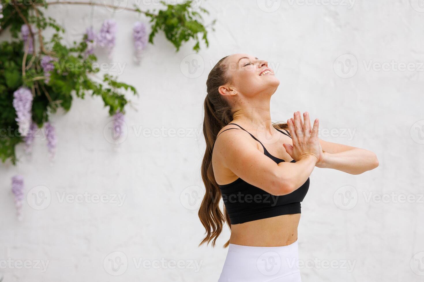 Woman practicing yoga outdoors photo