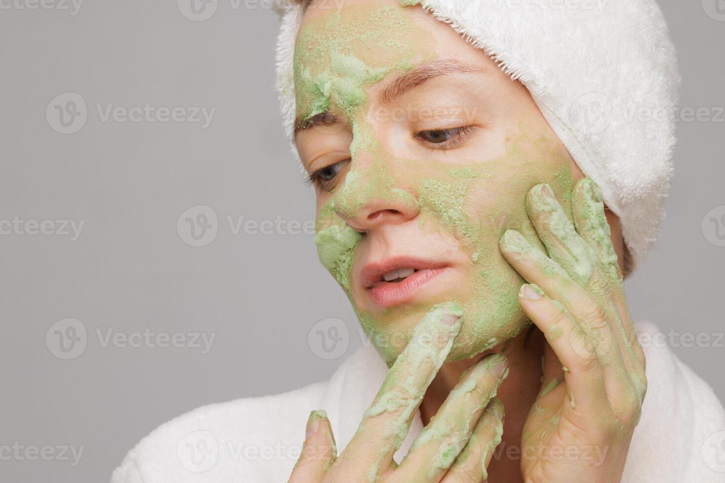 Woman Applying Green Oxygen Cleansing Foam Face Mask for Skincare and Beauty Treatment at Home photo